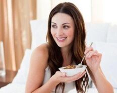 The girl eats a buckwheat porridge